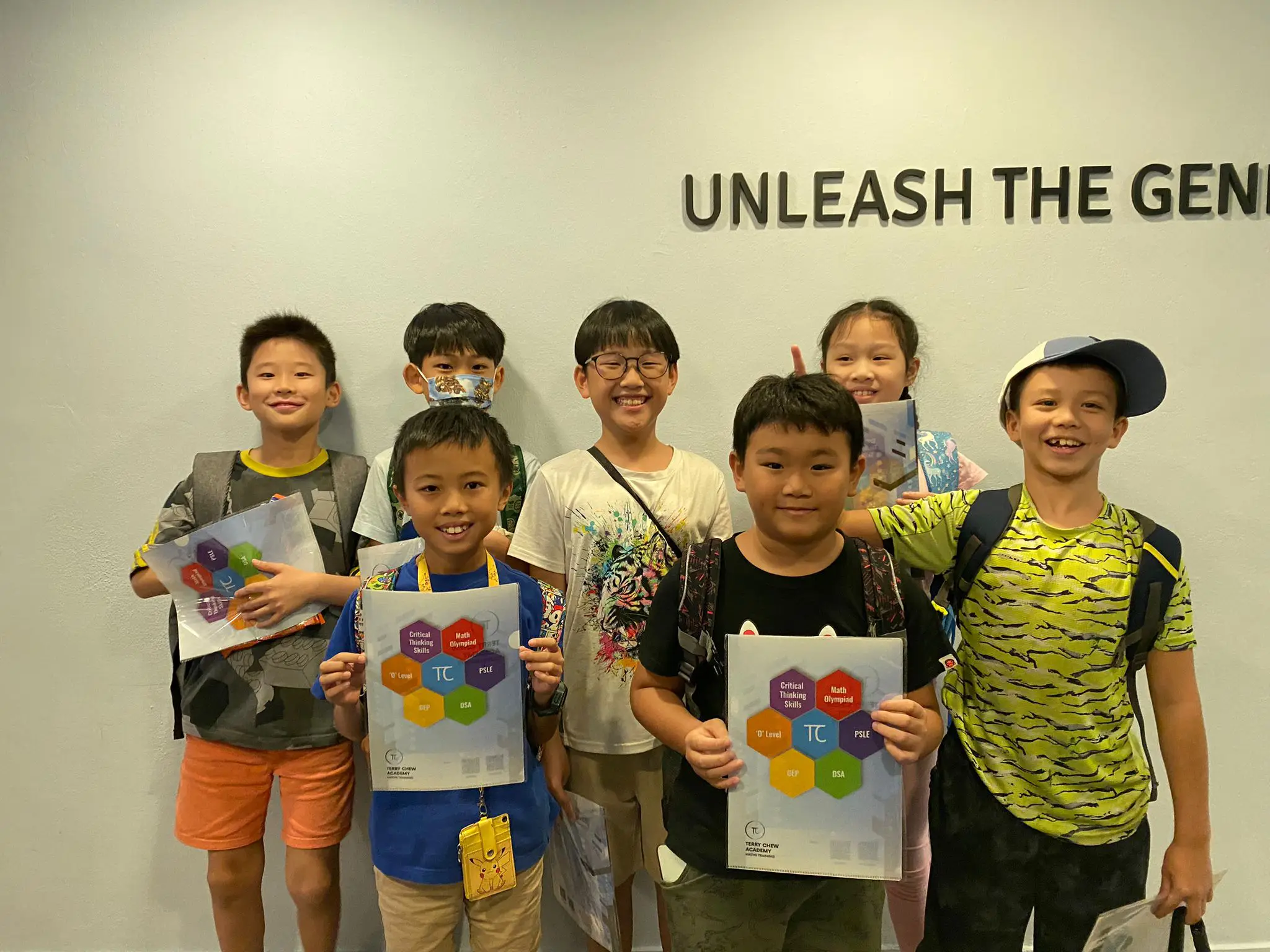 Students from Terry Chew Academy's Math Olympiads Training Program, holding their workbook
