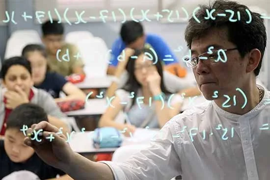 Teacher explaining advanced problem-solving concepts to students during a math enrichment class.