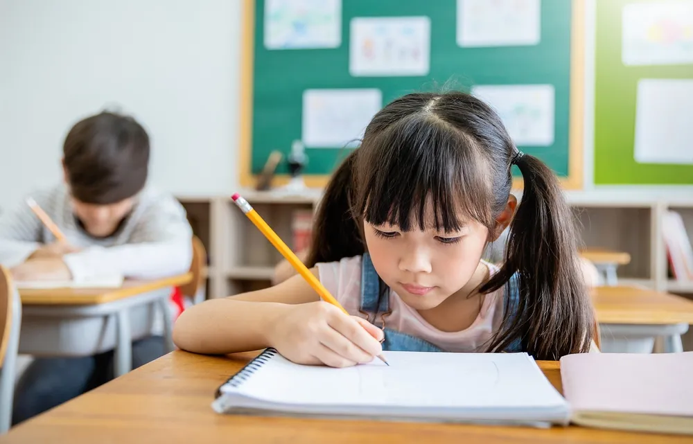 a child enrolled in a math olympiad programme deep in thought