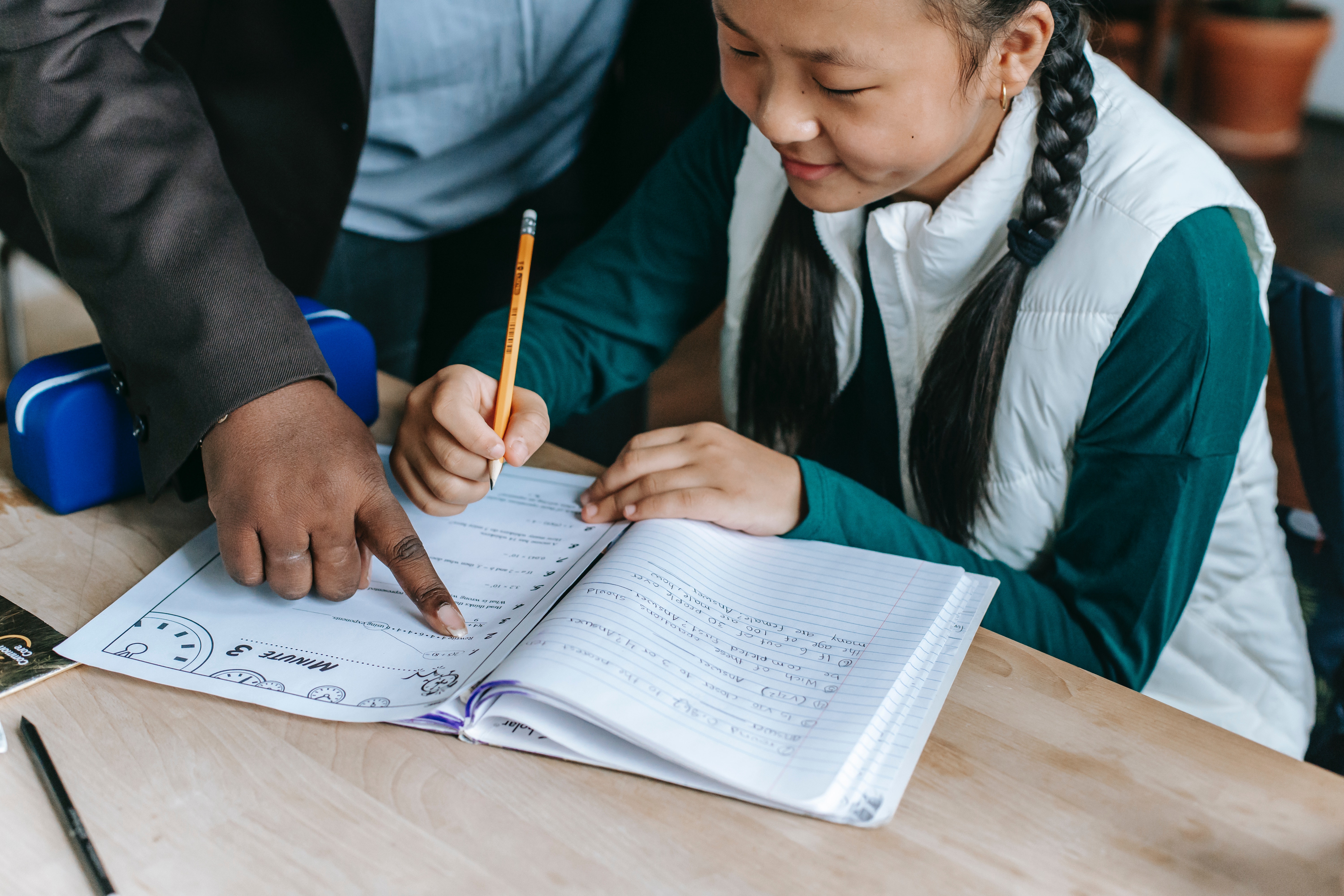 A tutor helping a student understand the material in preparation for maths competitions in Singapore