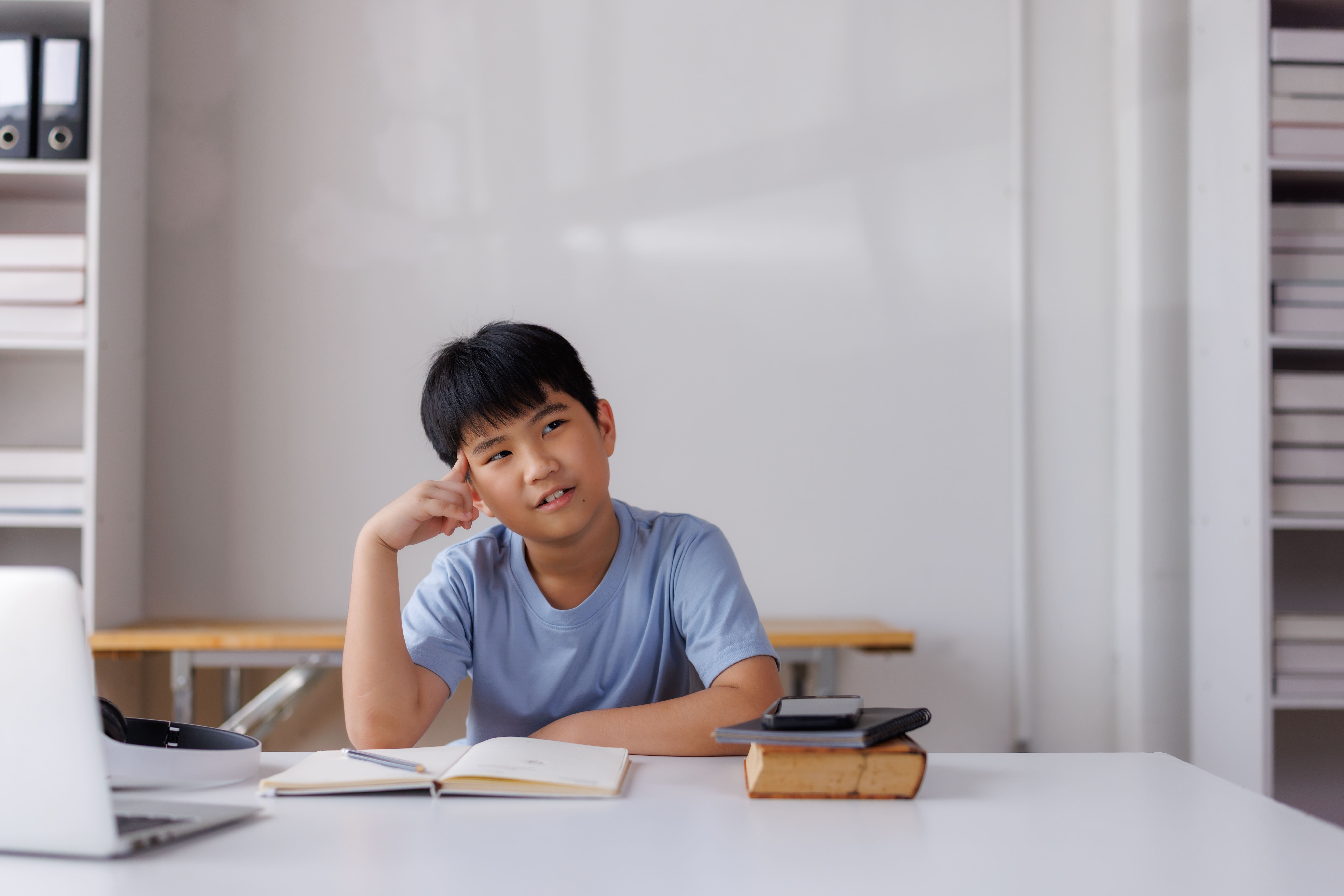 a young math olympiad trying to use his critical thinking skills in answering PSLE Paper 2 problem sums