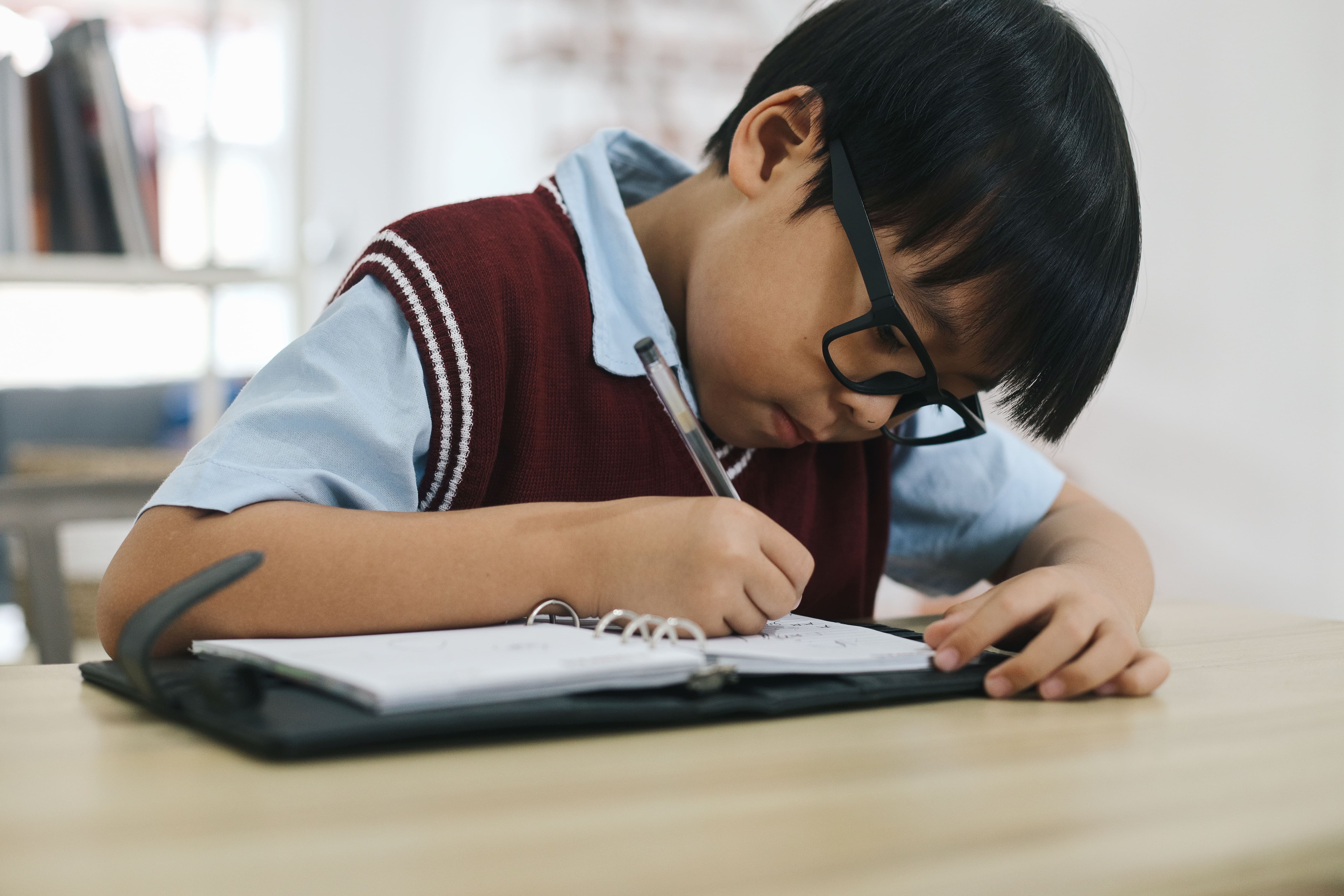 Primary student working through an unfamiliar maths problem