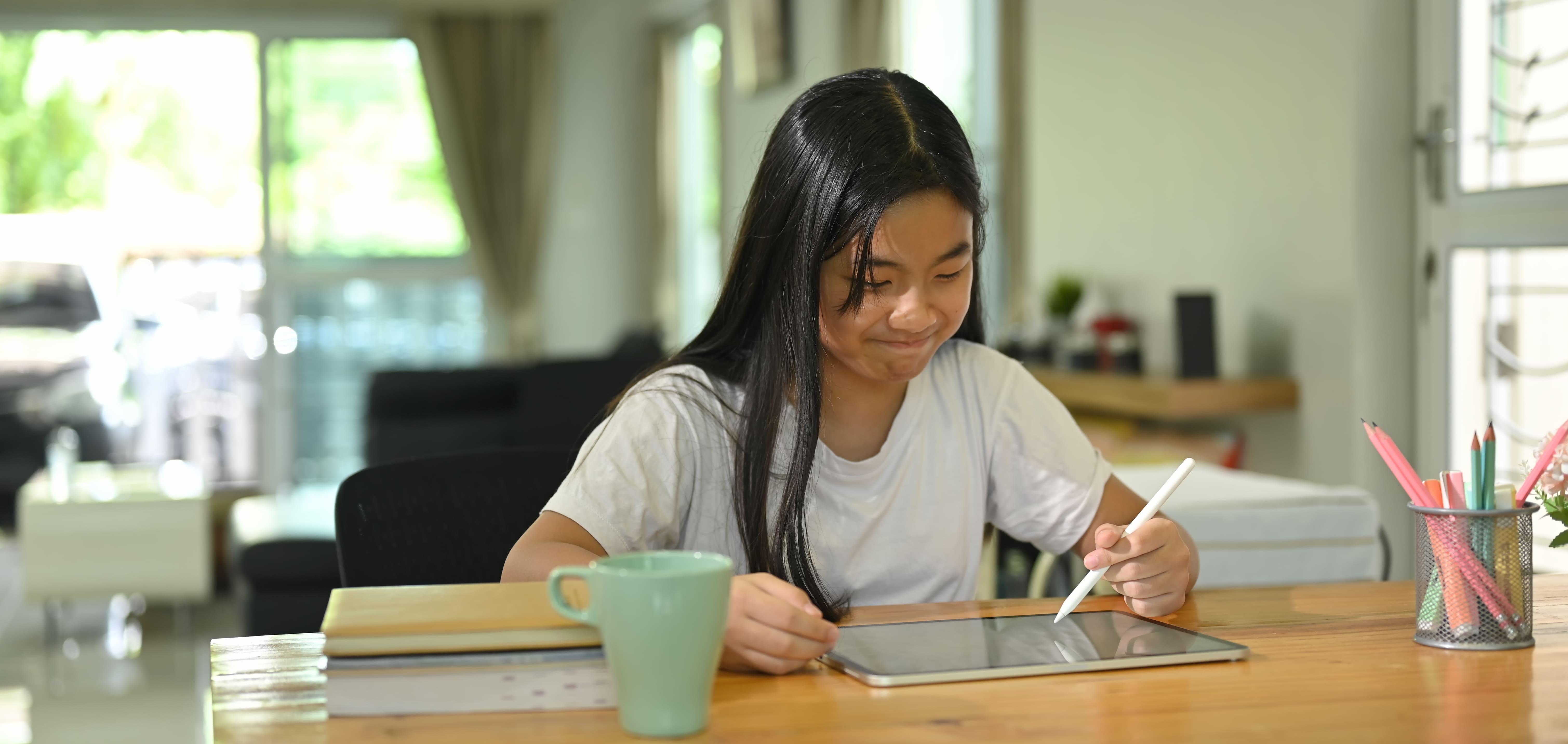 Student reviewing Maths work on a tablet to identify learning gaps before year-end exams.